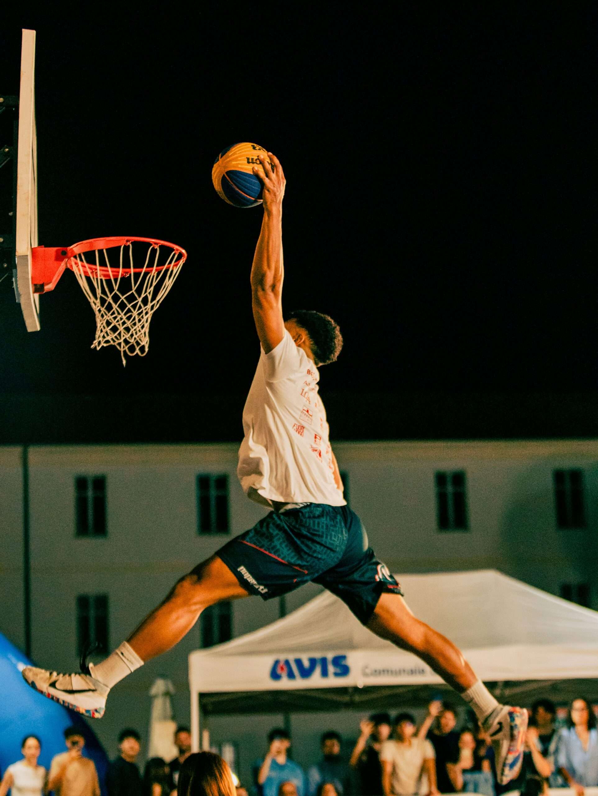 F.A.Q. Athlete performing a slam dunk.